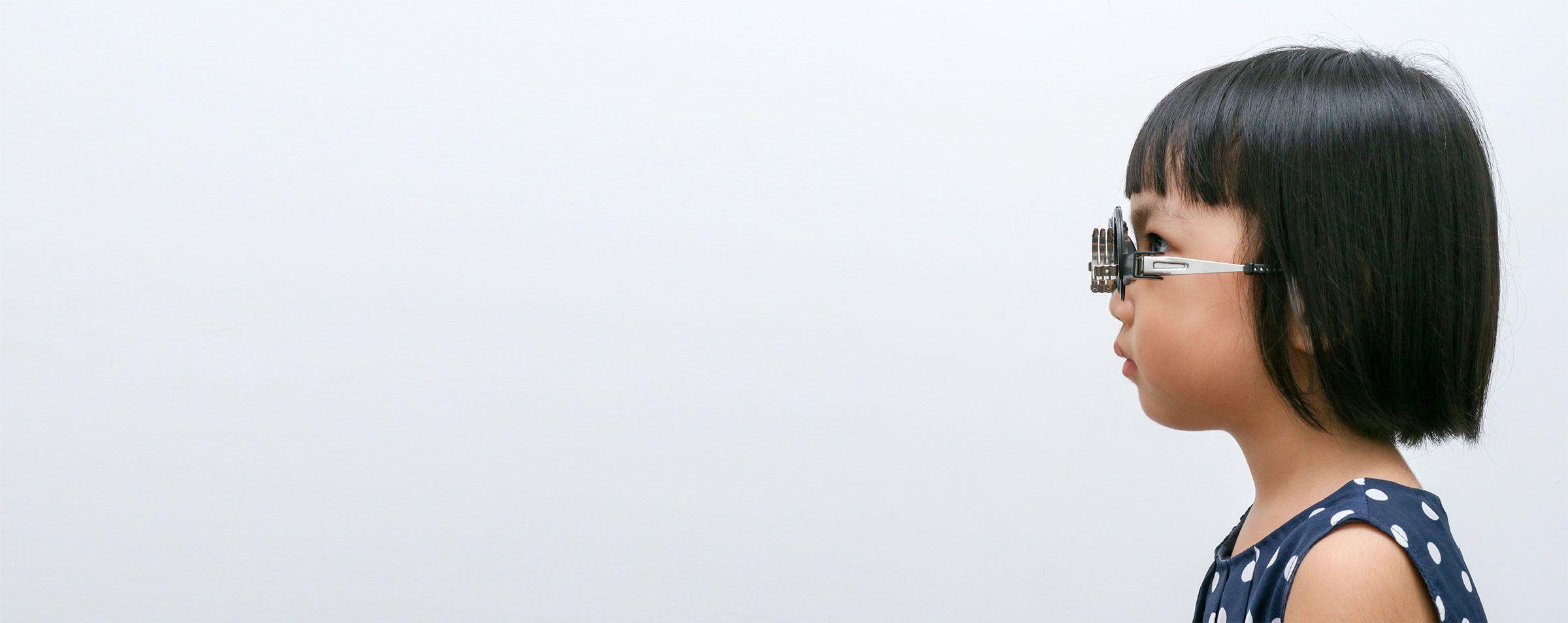 child doing refraction on white background