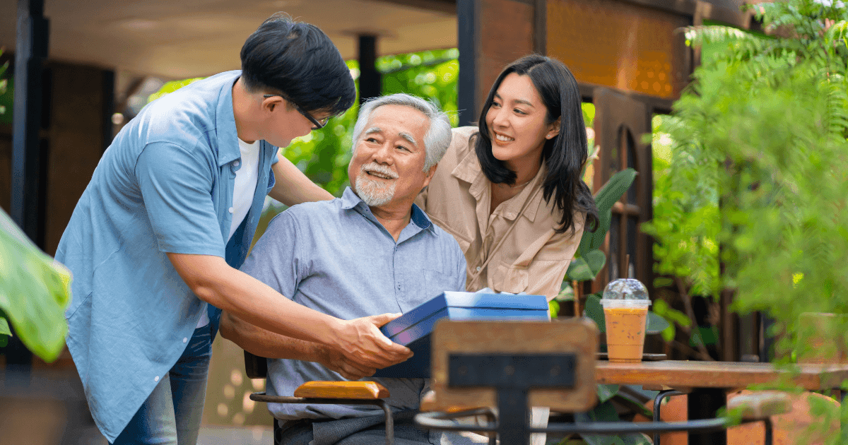 Asian family caring for an elderly father during Father’s Day in Singapore.