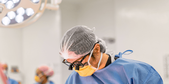 eye surgeon with loupes performing procedure