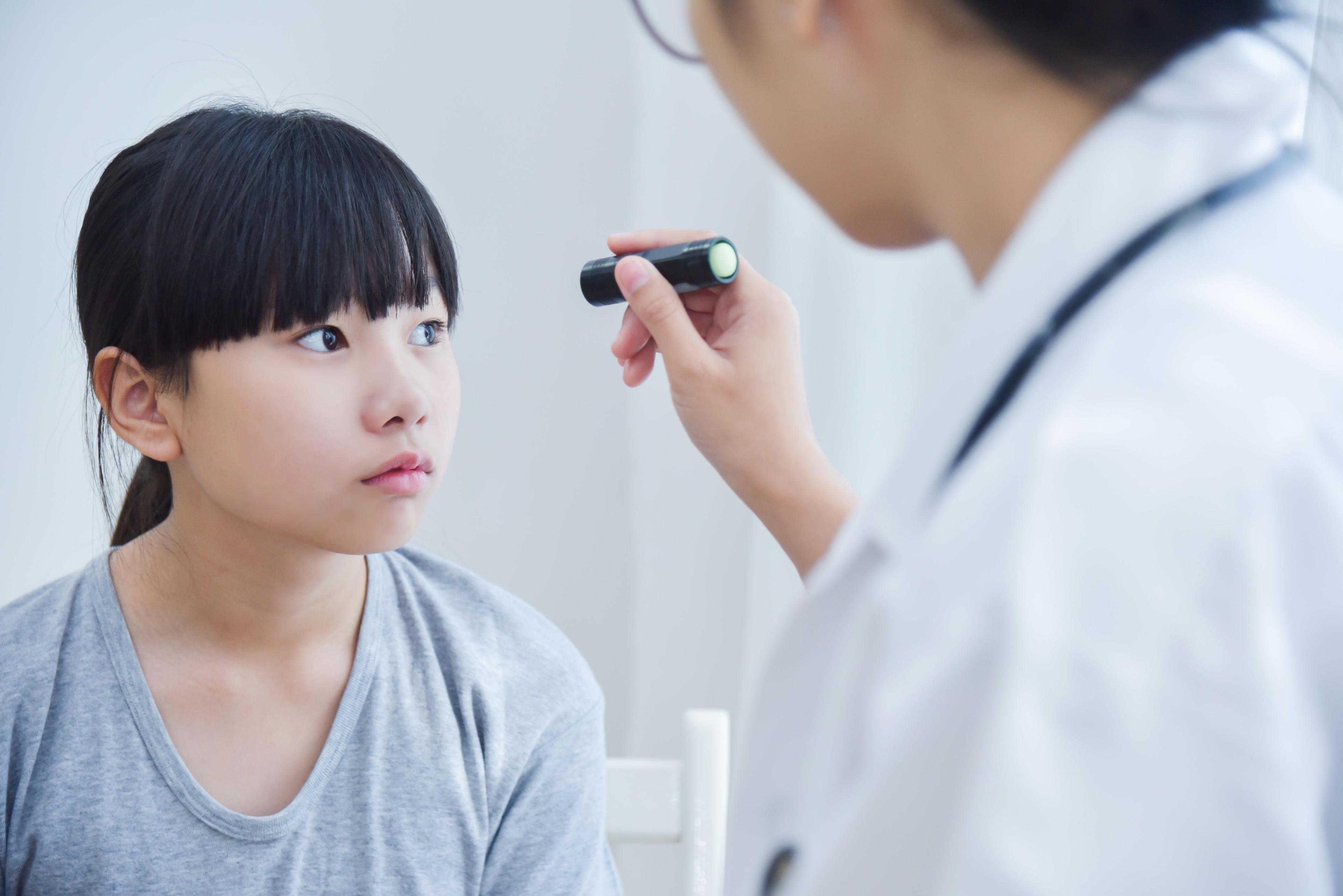 young asian female having eyes checked