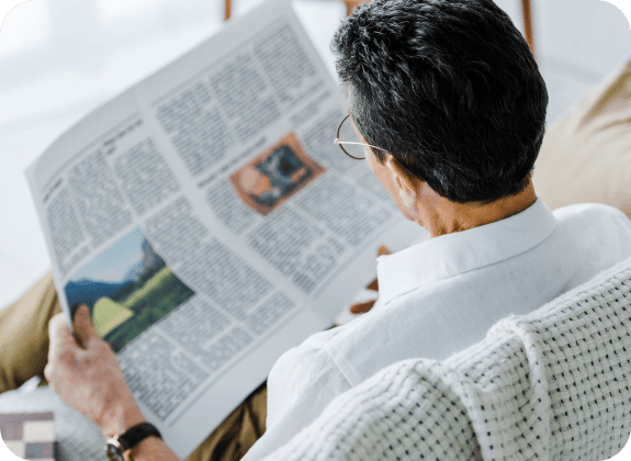 man reading newspaper with glasses for presbyopia management