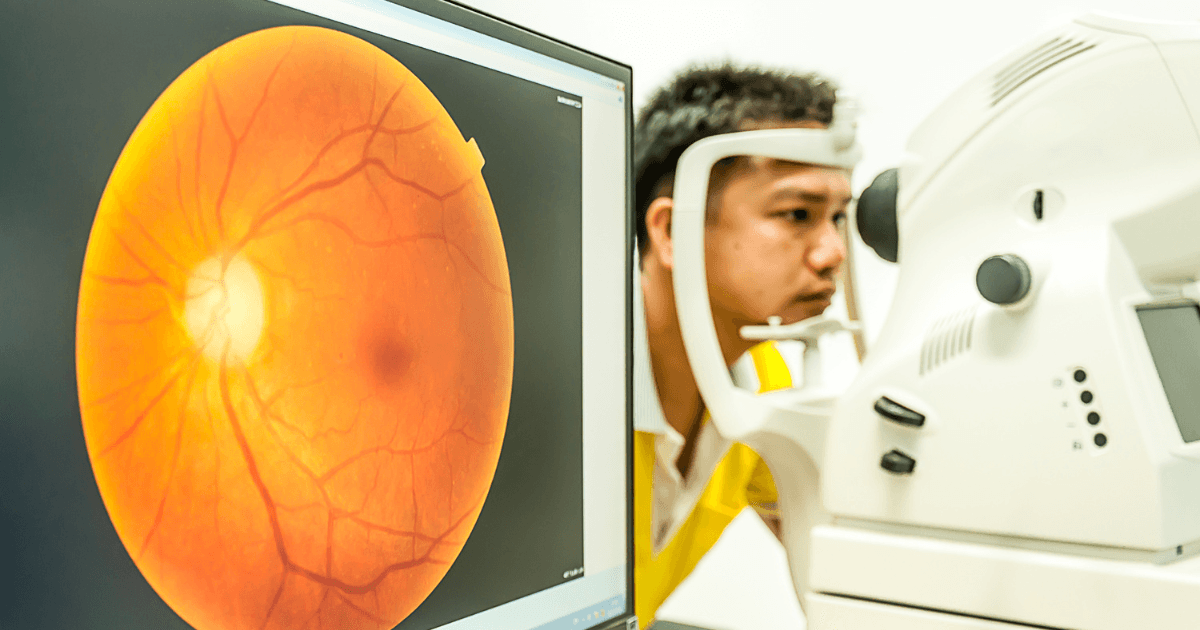 Retinal imaging test showing a patient undergoing an eye scan with a retina image on screen
