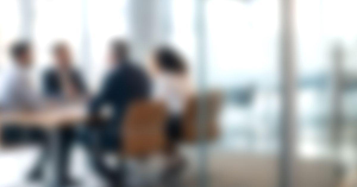 blurred image of people in office
