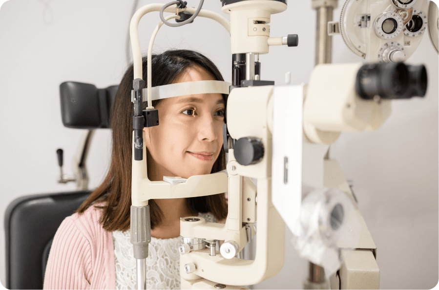 patient undergoing eye examination with diagnostic equipment
