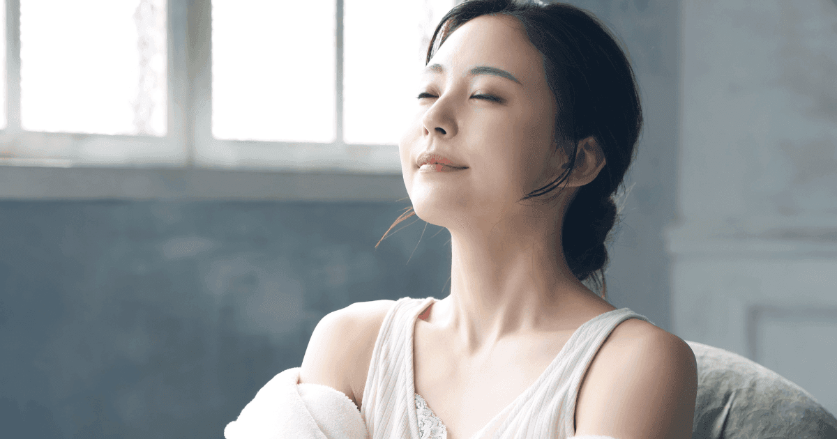 Woman resting her eyes in natural light, representing healthy eye habits and lifestyle support for hyperopia