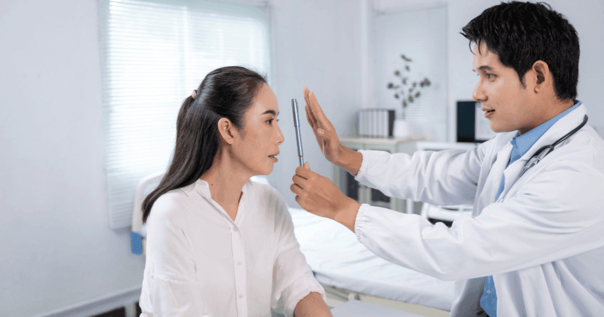 Eye doctor checking a patient’s vision during an astigmatism consultation