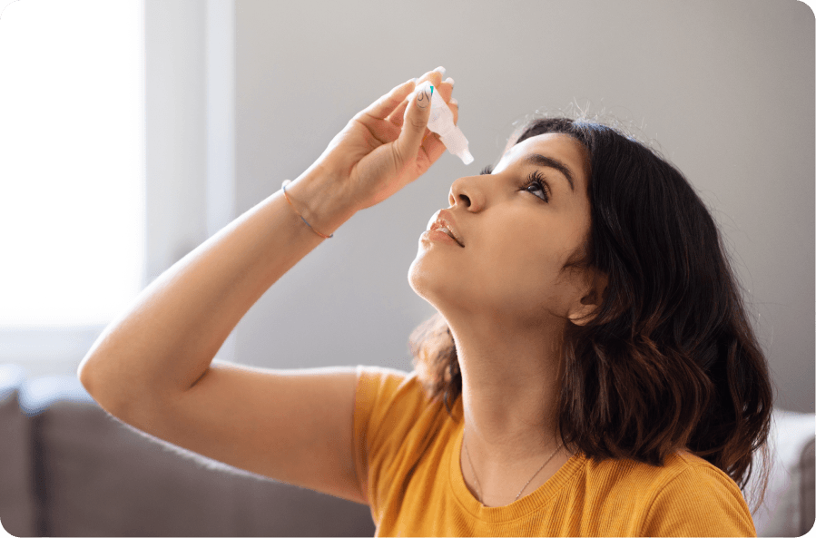 woman applying eye drops for mild pterygium treatment