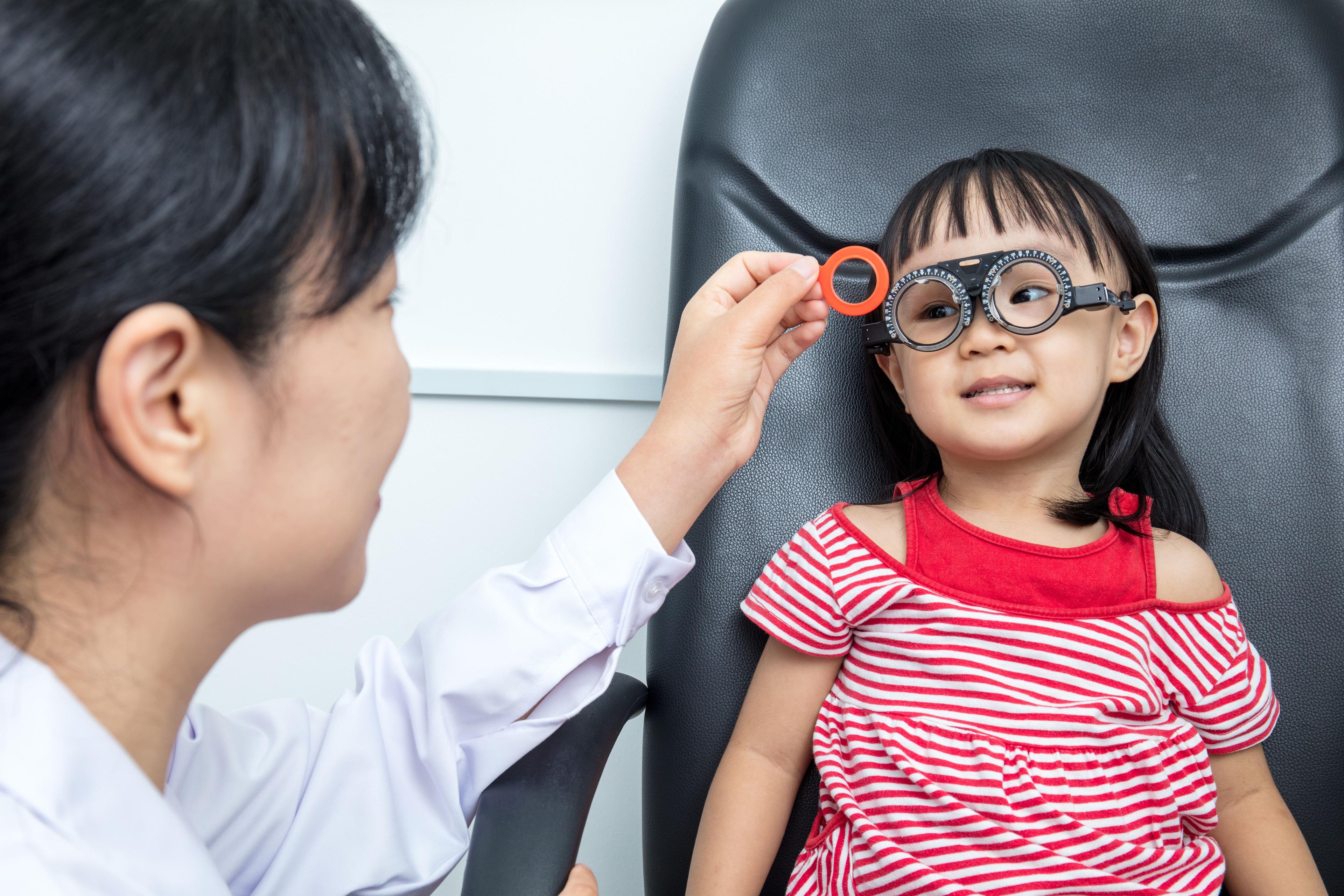 child having a refraction test at a clinic