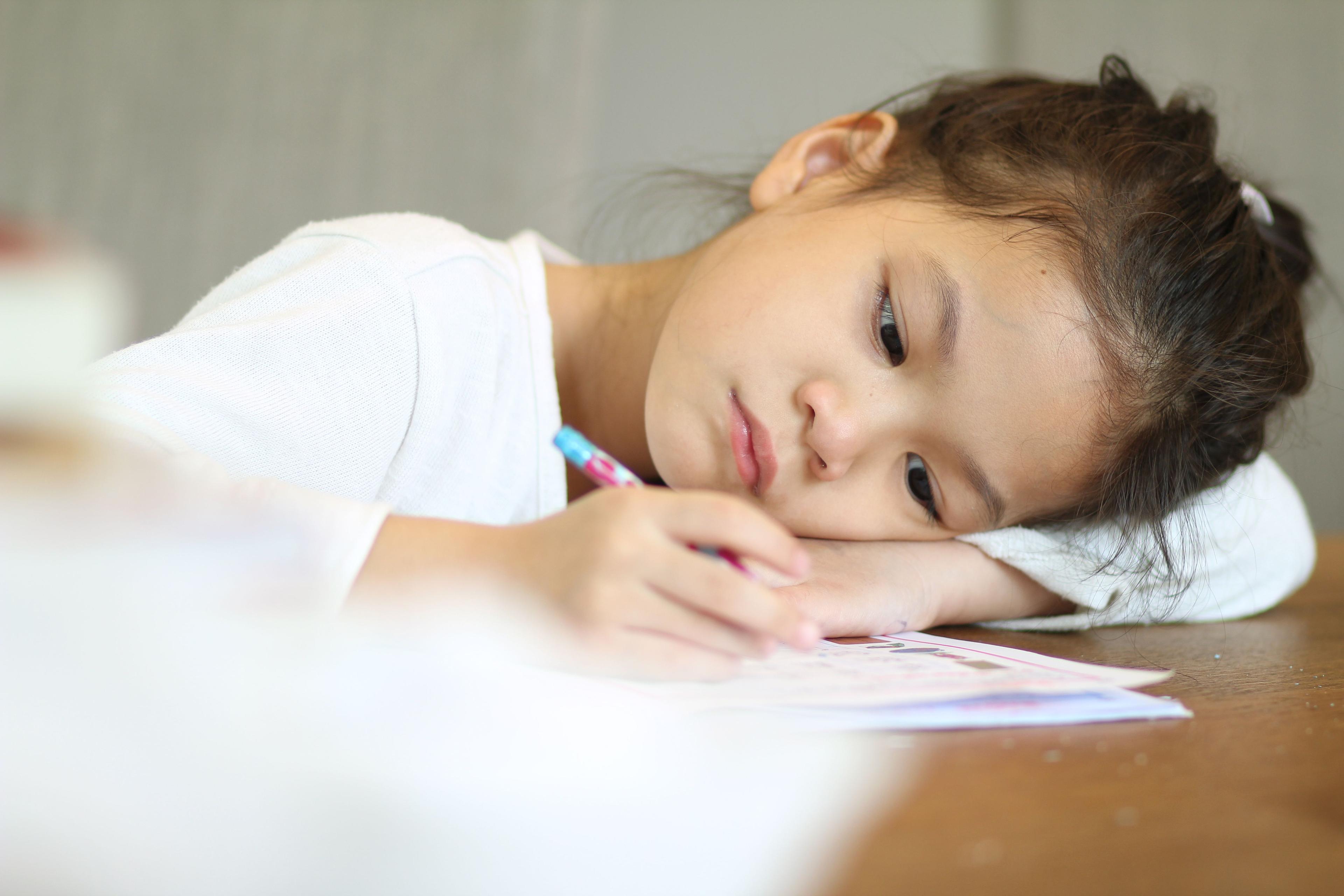 asian kid not in the mood to read and learn